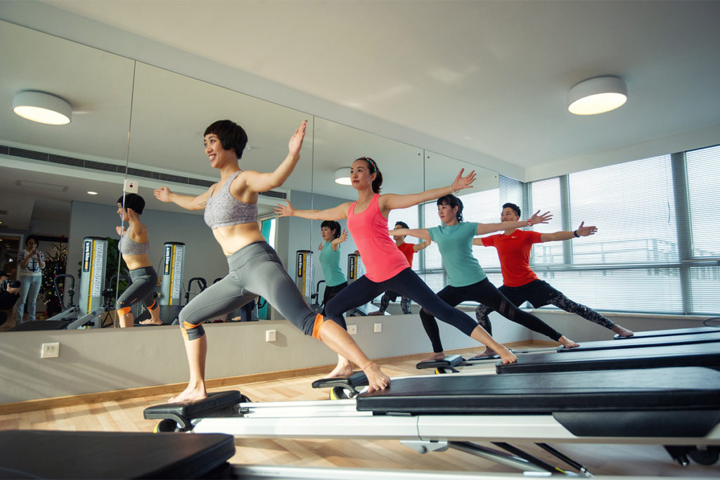 Pilates instructor teaching a class