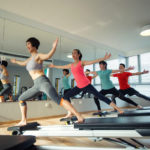 Pilates instructor teaching a class