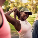 Women stretching and exercising during a park workout