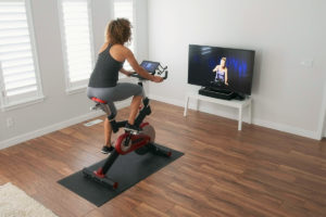 Woman taking a virtual fitness cycling class