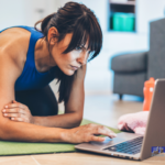 A woman taking FiTOUR education courses on a laptop