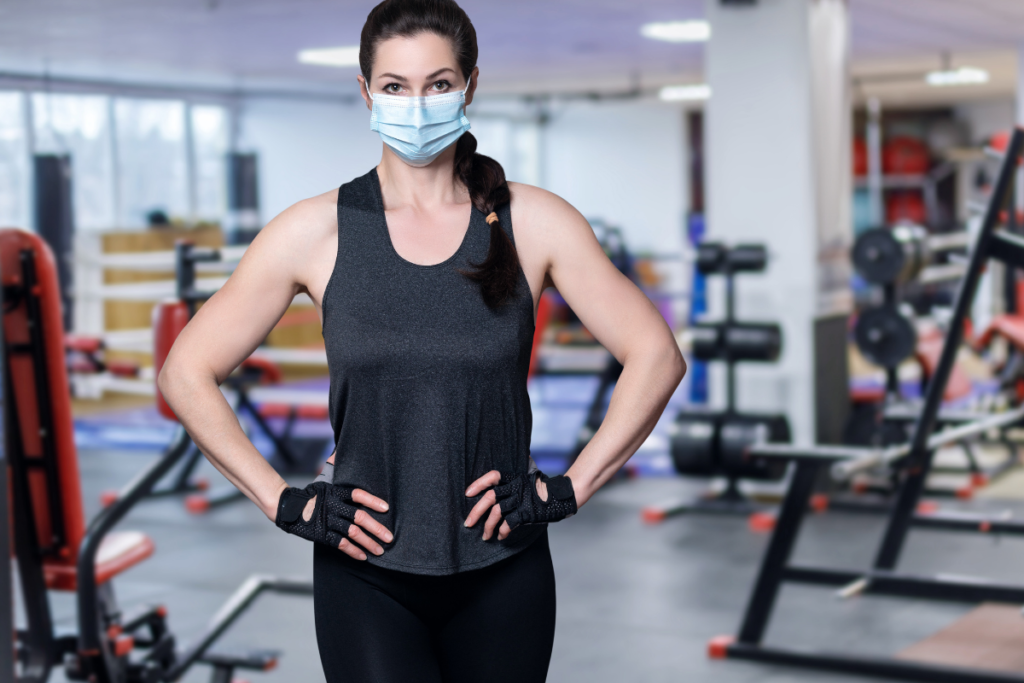 Woman wearing face mask post-pandemic at gym