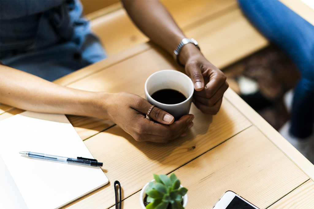 A person holding a cup of coffee