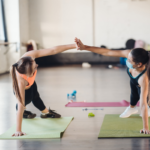 Two women exercising with masks on