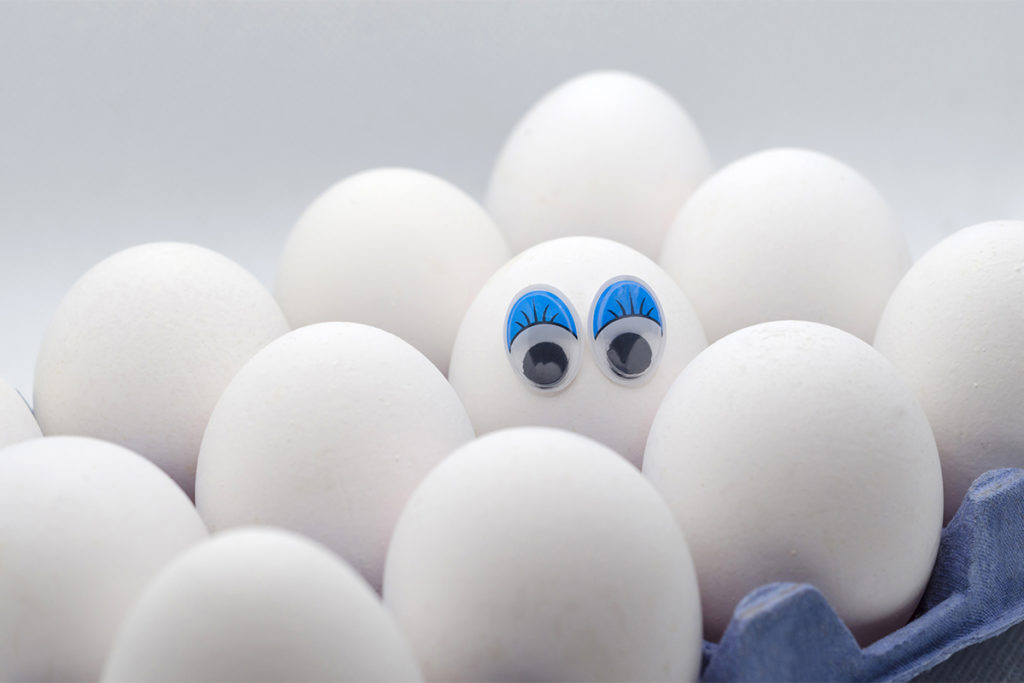 White eggs with eyes in carton