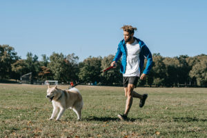 Young man doing moderate activity with a dog at the park