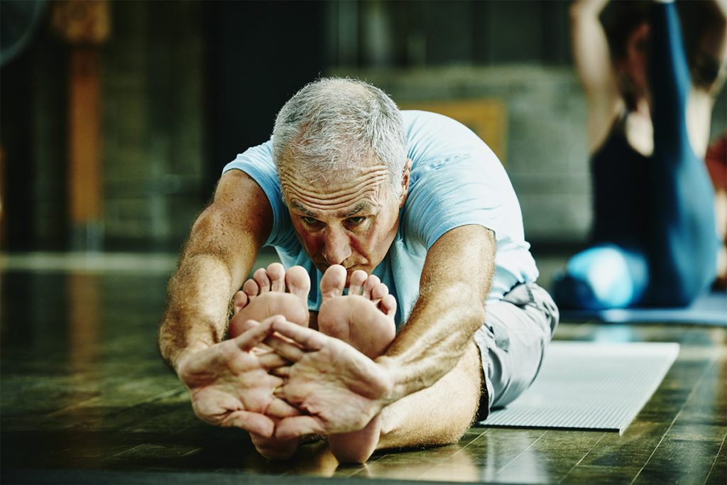 Older man stretching for hypertension