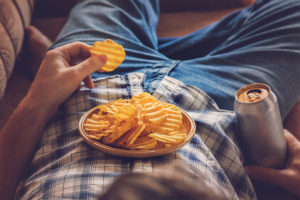 Person snacking on potato chips