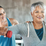 Trainer helping a woman with functional training