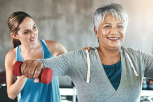 Trainer helping a woman with functional training