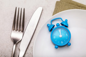 Fork and clock to represent hunger and blood sugar
