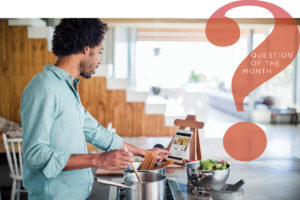 Man cooking with social media recipes in the kitchen