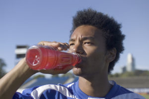 Athlete consuming pink sports drink