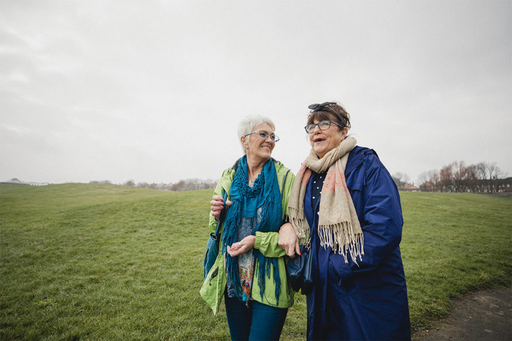 Two women walking to get their daily steps in