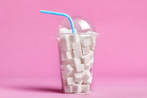 Sugar cubes in a plastic cup to represent excessive sugar in soda
