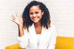 Woman waving with wrist joint