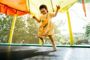 Young girl exercising in a bounce house