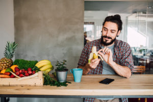 Man using food apps while eating