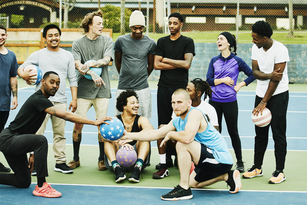Group of young people training outside with a split workout