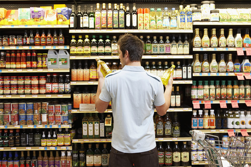 Person shopping for vegetable oils
