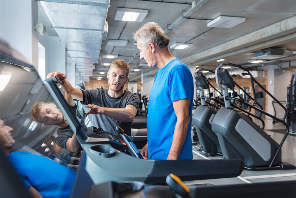 Trainer helping client with walking after a stroke