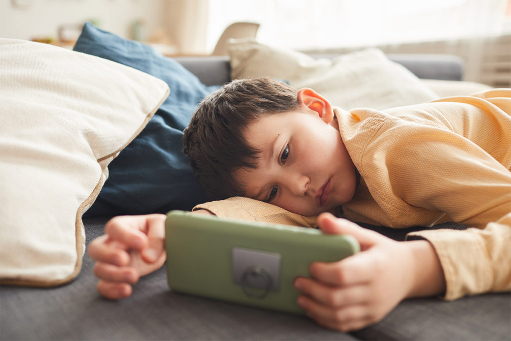 children's mental health decline shown with child looking at a phone sadly
