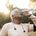 Older athlete following health education by hydrating