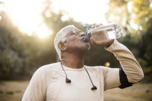 Older athlete following health education by hydrating