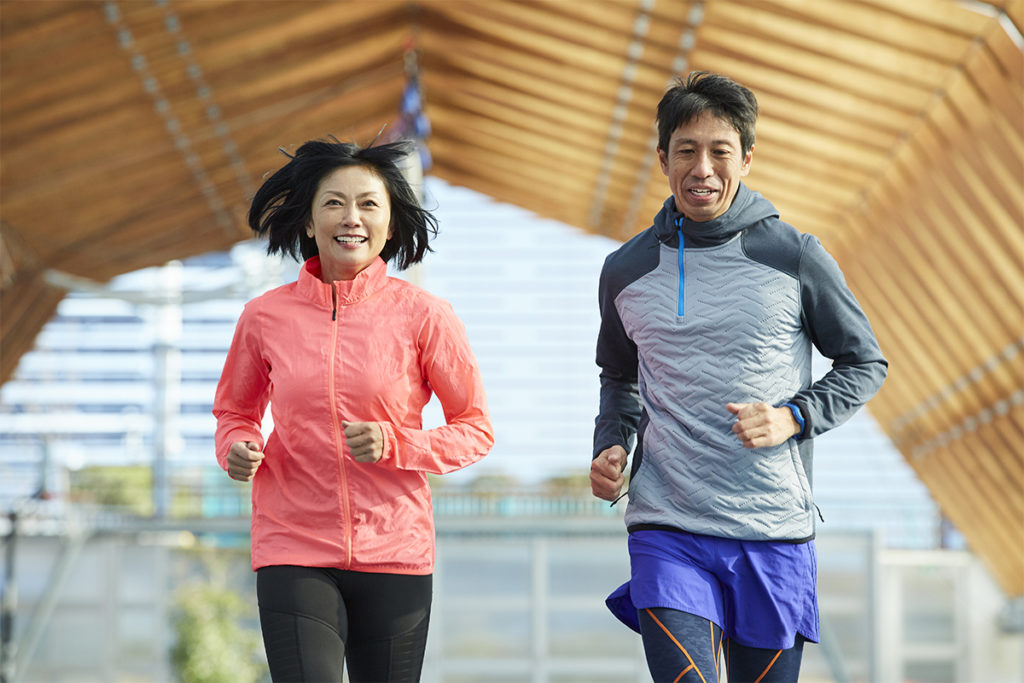 Two people doing moderate-to-vigorous physical activity by running