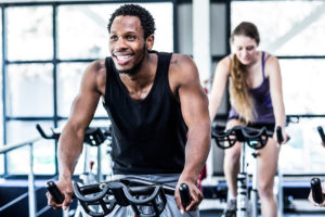 People taking indoor cycling class