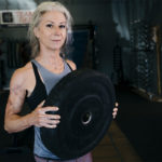 Older woman lifting for muscular hypertrophy