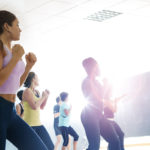 Group exercise class workout out to music playlists