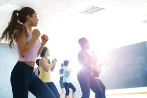Group exercise class workout out to music playlists