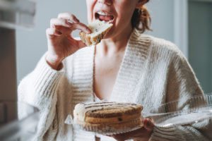 Woman snacking from nicotine withdrawal