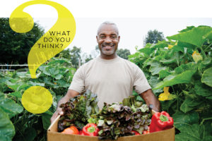 Man carrying box of produce with pesticides