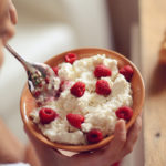 Person eating bowl of dairy protein