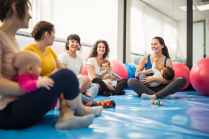 Postpartum moms in group fitness class