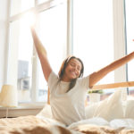 Woman waking up with better sleep quality