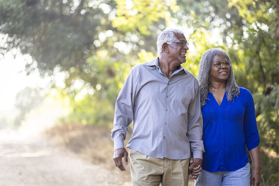 Older couple walking outside for vitamin d