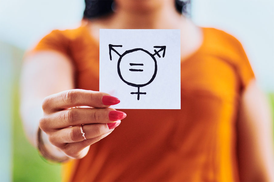 Person holding gender inclusivity sign