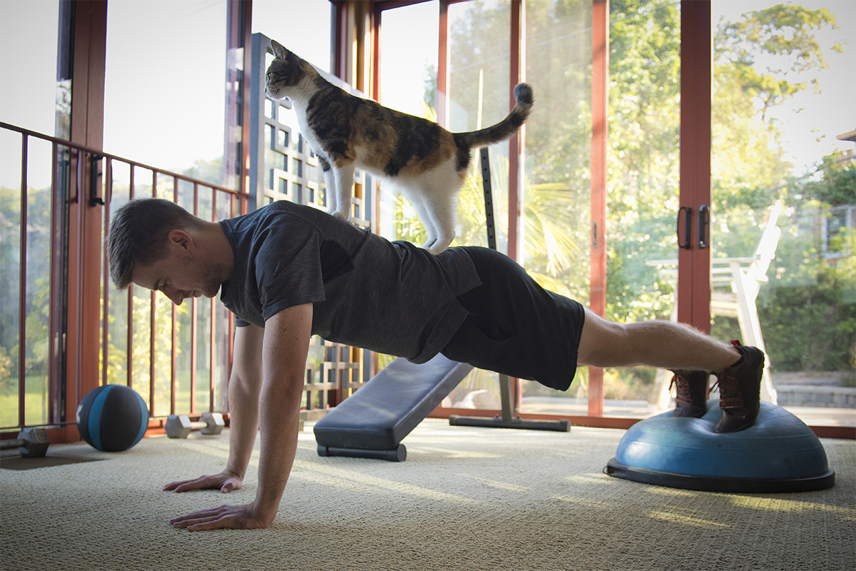 Man exercising with cat