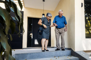Elderly couple walking down stairs to show importance of spatial awareness and proprioception
