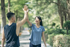 Two people high fiving during exercise for resilience