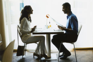 Two people dining and looking at restaurant calories