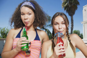 Young girls drinking sweetened beverages