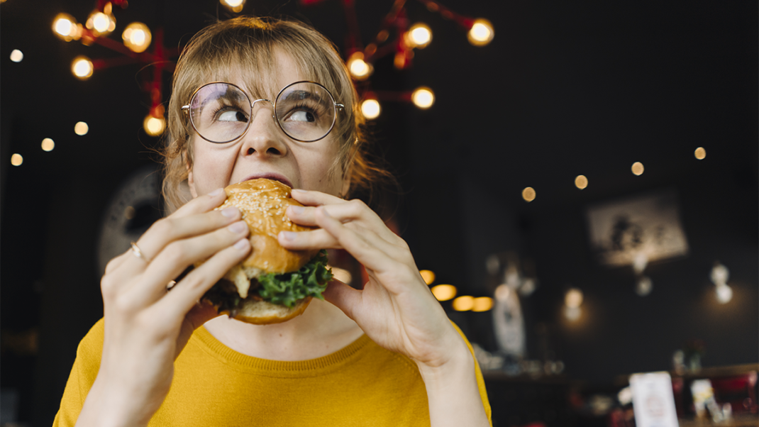 Woman overeating ultraprocessed foods