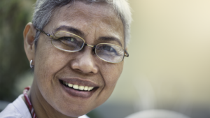 Woman smiling to show link between sugar and teeth