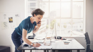 Woman using benefits of standing at work