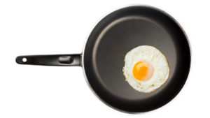 Egg on frying pan to represent chemicals linked to celiac disease