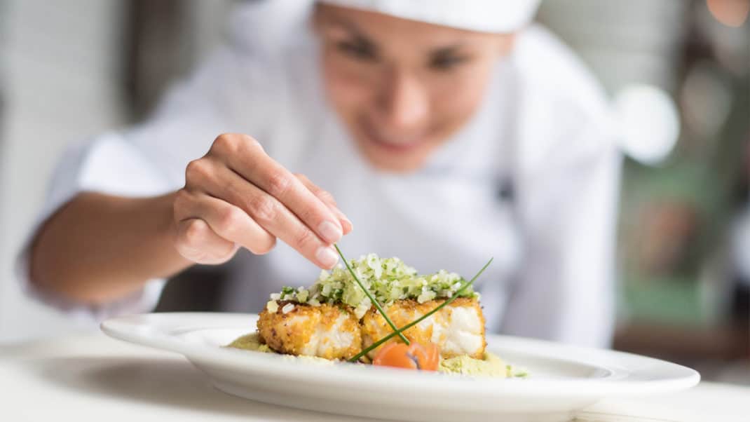 Chef plating food in cooking course